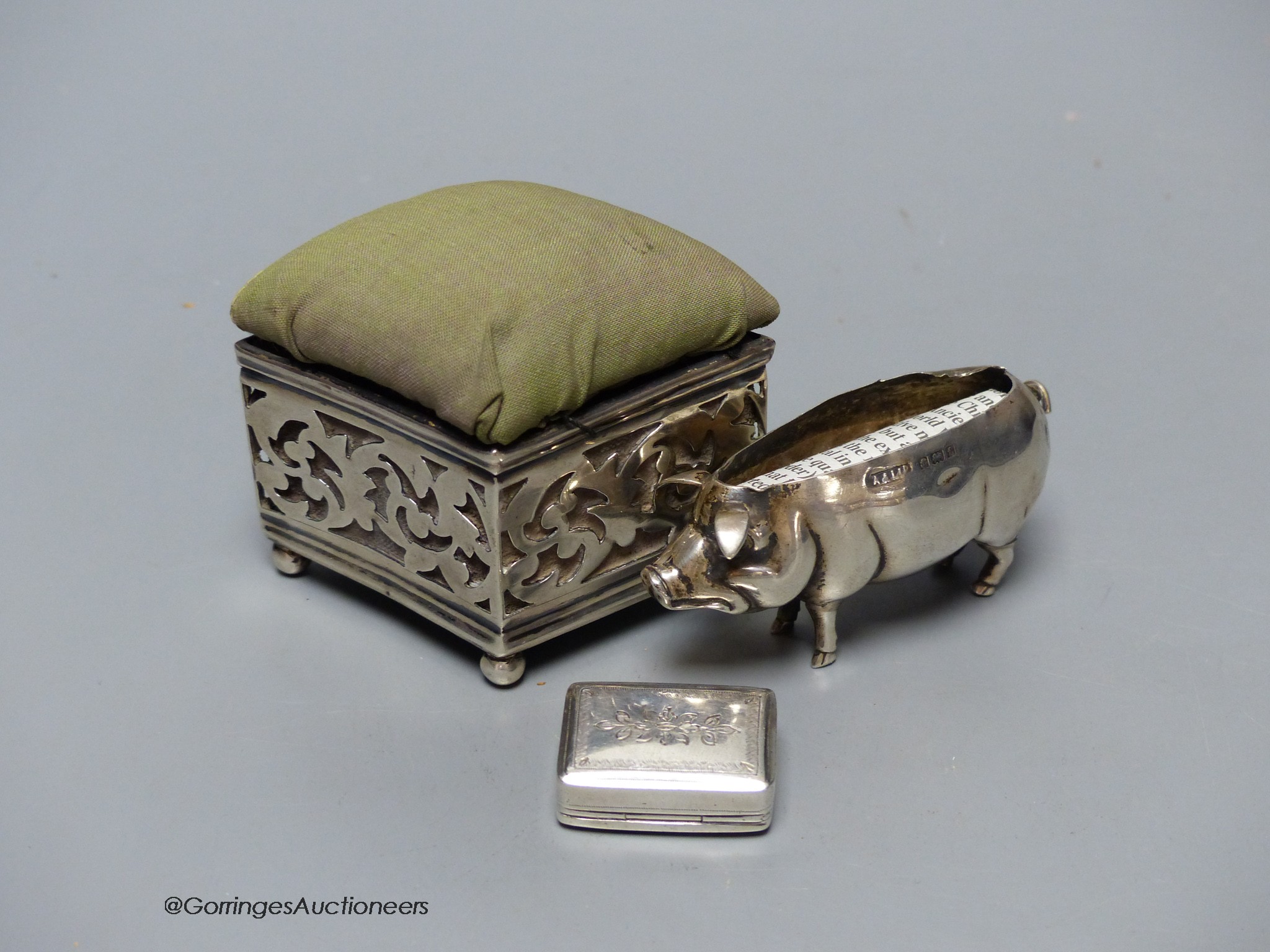 Two silver mounted pin cushions including a pig (lacking cushion) and a 19th century silver vinaigrette.